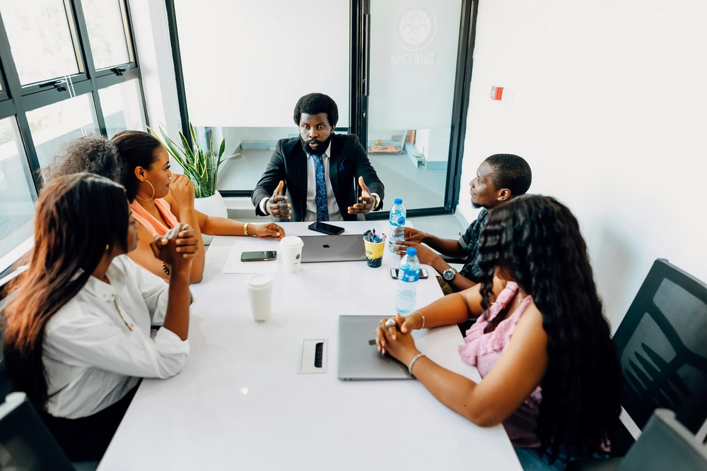 HR manager reviewing personalized employee benefits options with two employees in a California office