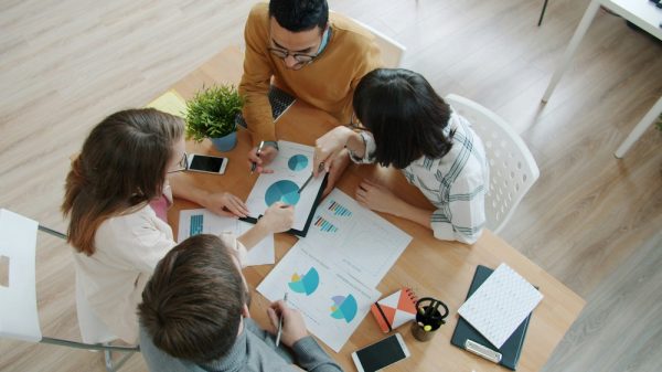 Small business owner reviewing employee benefits strategy with advisor in Irvine office
