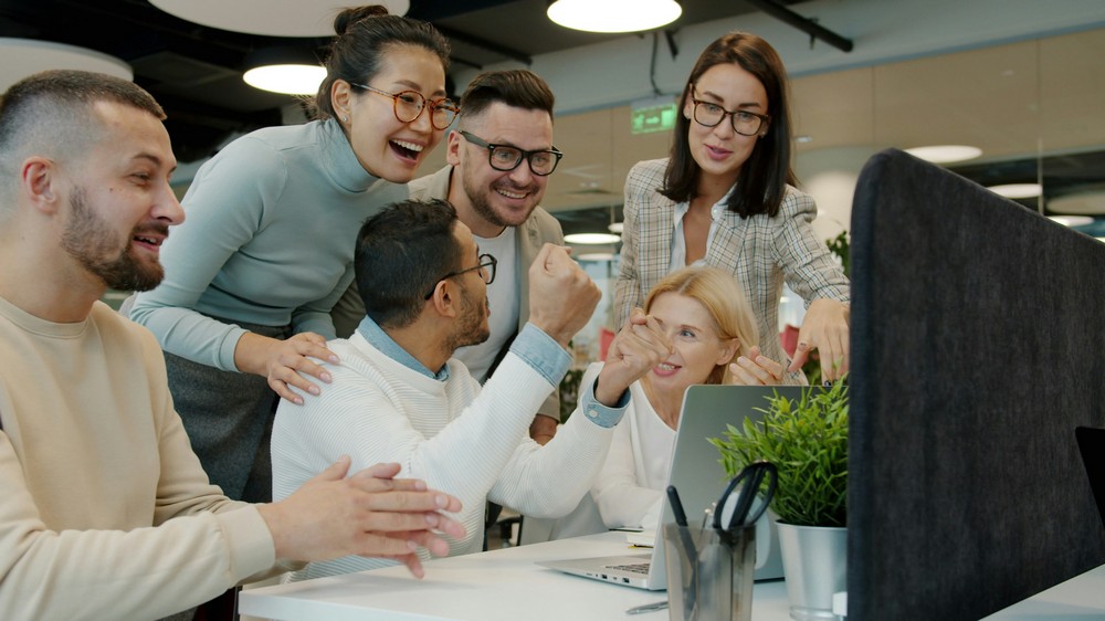 Benefits advisor reviewing group health insurance market trends on digital dashboard in Orange County office